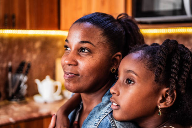 istock Mother and daughter looking away at home 2179856789