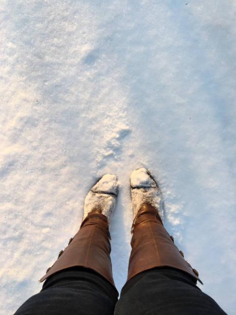 istock Winter Elegance: Knee-High Boots in the Snow 2179858977