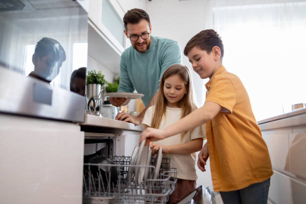 istock Family enjoying chore time together kitchen 2179859231