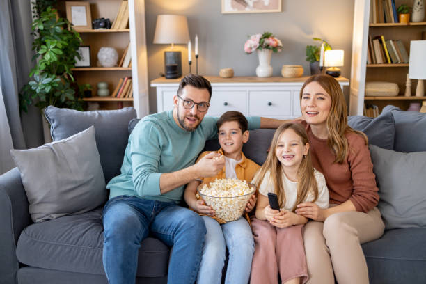 istock Family sharing popcorn during cozy TV watching moment 2179859232