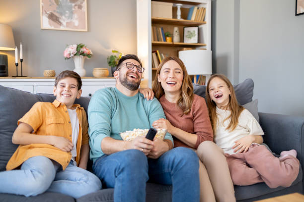 istock Family having a fun time watching TV and laughing 2179859233