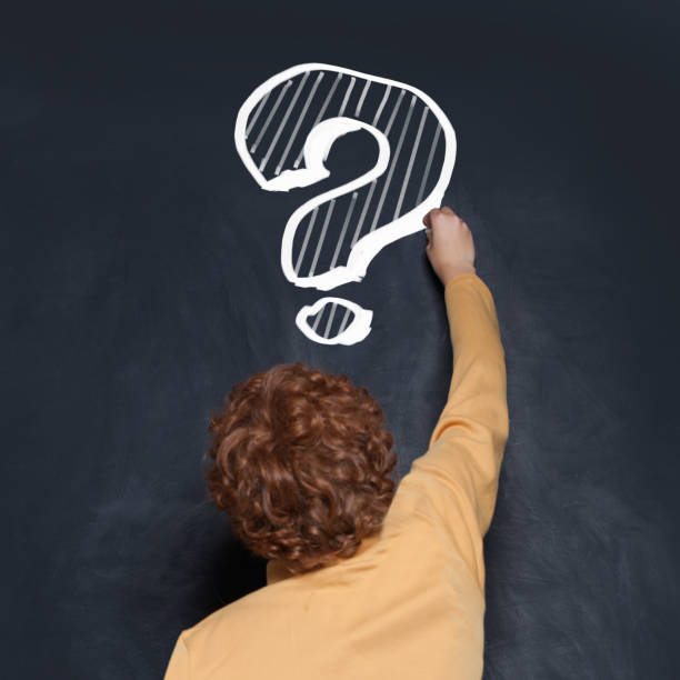 istock Redhead child boy school student writing question mark on blackboard. Idea and Education concept 2179859731