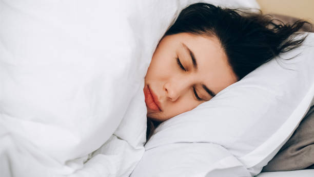 istock Early morning sleeping woman exhausted day bed 2179860155