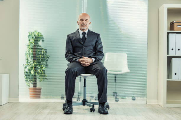 istock Confident businessman meditating in office for mindfulness at wo 2179868584