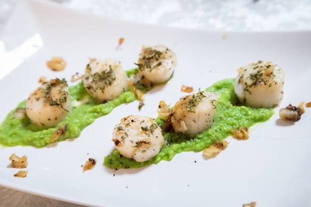 istock Gourmet Scallops with Herb Garnish on Green Bean Puree 2179871252