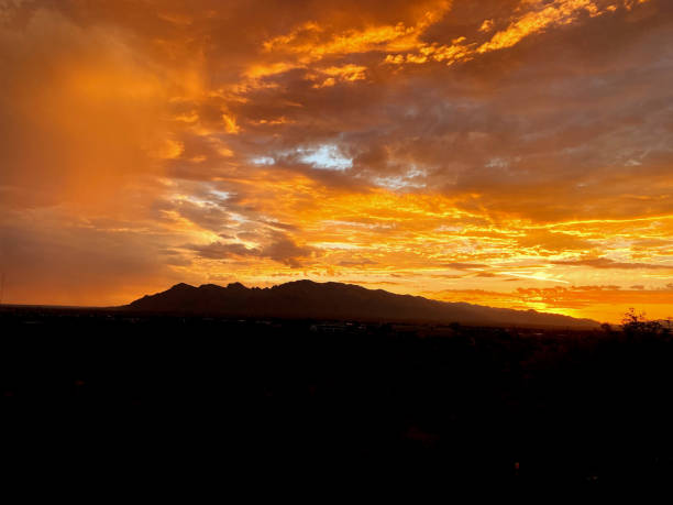istock Epic Sunset: Tangerine and Yellow Sky Over Dark Landscape 2179873128