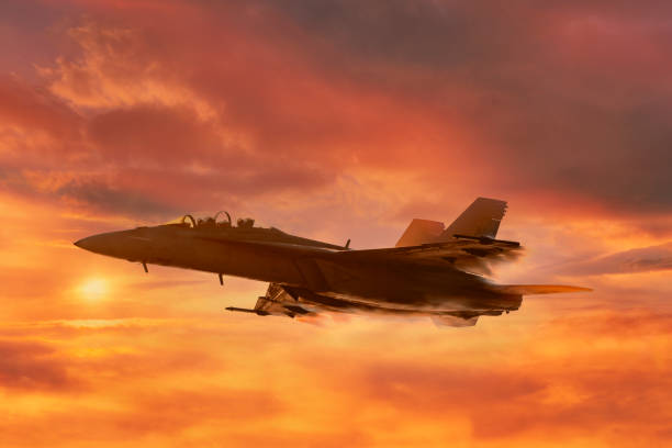 istock Military jet flies through cloudy skies 2179875927
