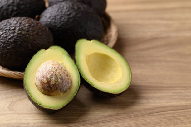istock Ripe Hass avocado fruit on wooden background 2179877571