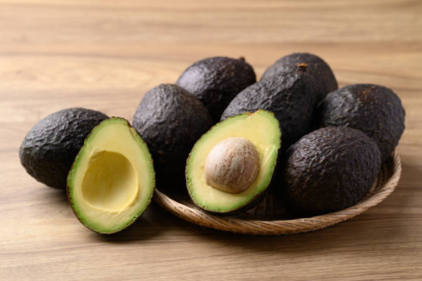 istock Ripe Hass avocado fruit in basket on wooden background 2179877600