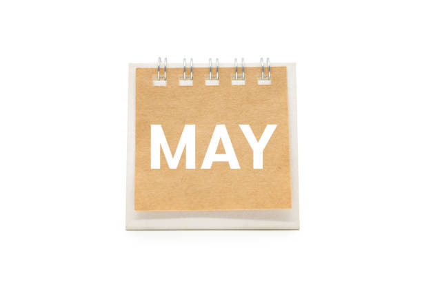 May 2025 - small spiral desktop calendar, time and business concept