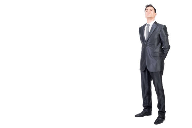 Studio shot of handsome bald multi ethnic businessman wearing suit against colored background