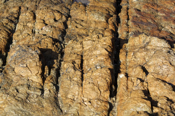 Full frame photo of the brown stone slopes with a beautiful texture on the Mediterranean coast near Marseille, Provence-Alpes-Cote d'Azur region.