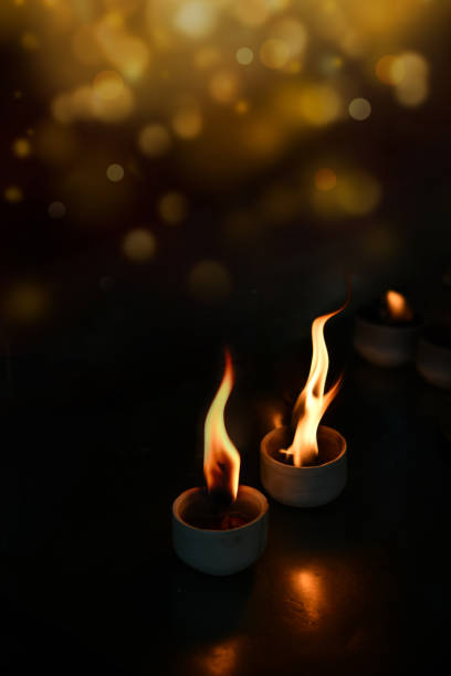 A candle flame is visible through a light bulb in the dark,candle