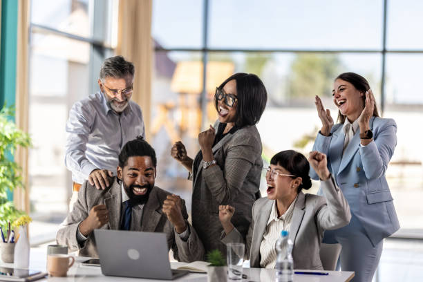 istock Business team celebrating success with raised hands 2179895290