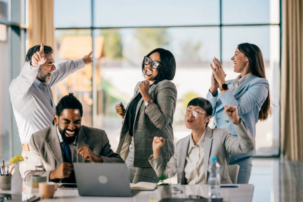 istock Business team celebrating success with raised hands 2179895295