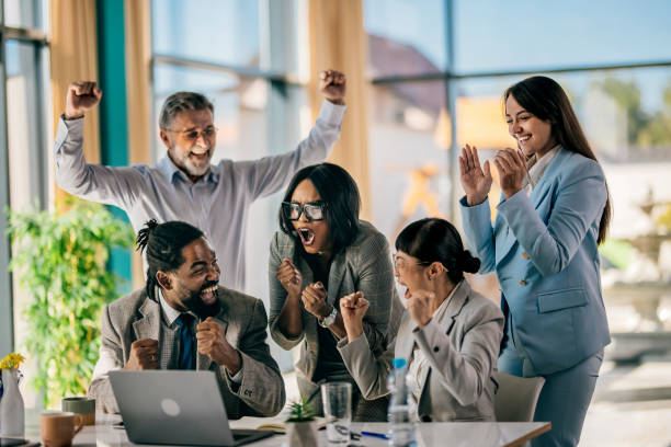 istock Business team celebrating success with raised hands 2179895309