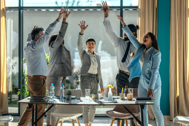 istock Business team celebrating success with raised hands 2179895366