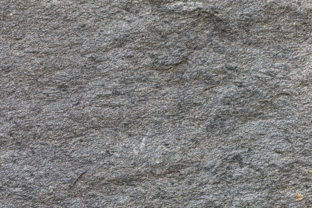 istock Rough texture of gray stone wall. close up 2179898463