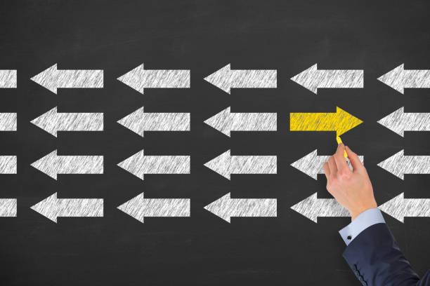 istock Going Your Own Way with Arrows Symbol on Blackboard Background. 2179902934