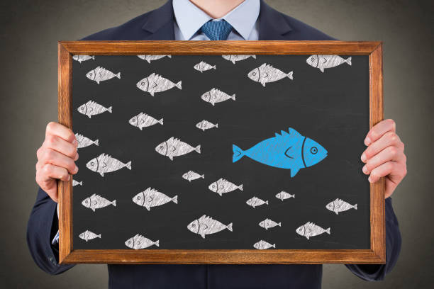 istock Going Your Own Way with Fishes on Blackboard Background. 2179903321