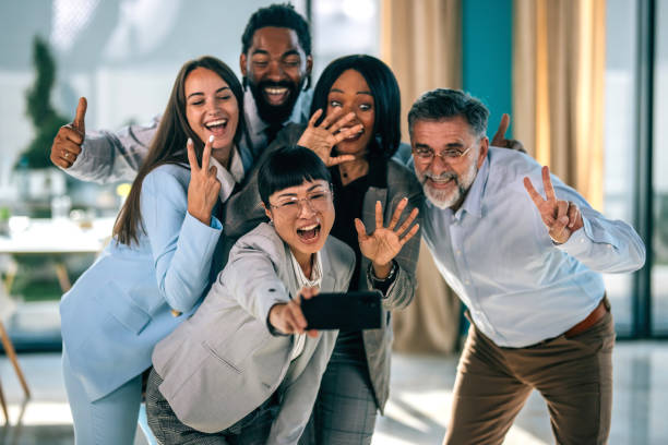 istock Successful business team taking selfie. Multi-ethnic business group taking a self portrait in office. 2179908282