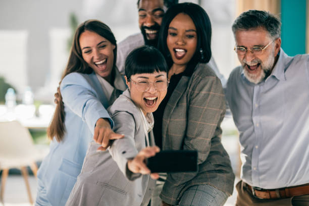 istock Successful business team taking selfie. Multi-ethnic business group taking a self portrait in office. 2179908286