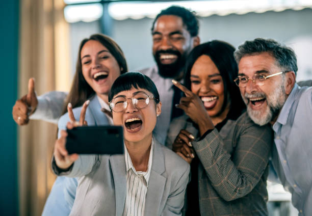 istock Successful business team taking selfie. Multi-ethnic business group taking a self portrait in office. 2179908292