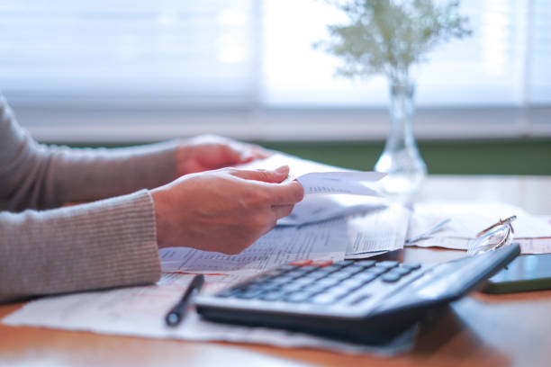 istock Close-up Hands calculating taxes on a desk 2179920245