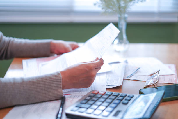 istock Close-up Hands calculating taxes on a desk 2179920248