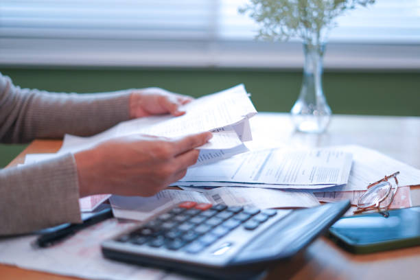 istock Close-up Hands calculating taxes on a desk 2179920275