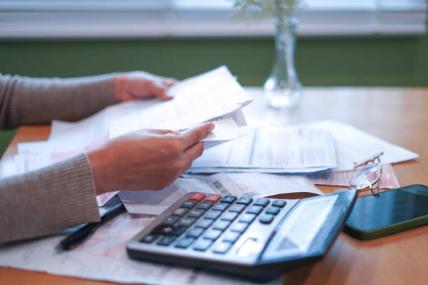 istock Close-up Hands calculating taxes on a desk 2179920278