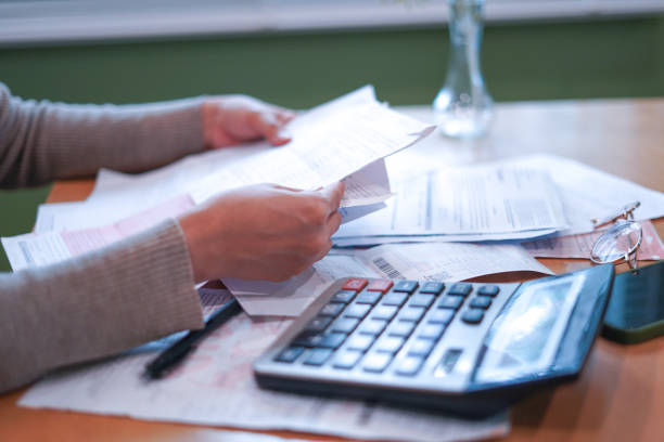 Close-up Hands calculating taxes on a desk
