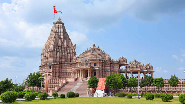 View of the newly built Shree Khondaldham Temple with carved sculptures of Hindu deities, Kagvad, Rajkot, Gujarat, India. View of the newly built Shree Khondaldham Temple with carved sculptures of Hindu deities, Kagvad, Rajkot, Gujarat, India. rajkot india stock pictures, royalty-free photos & images