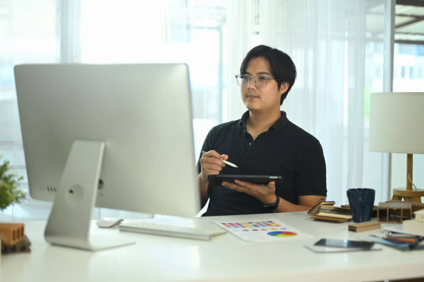 istock Interior designer working with a digital tablet and stylus, sketching or reviewing design project at office 2179924822