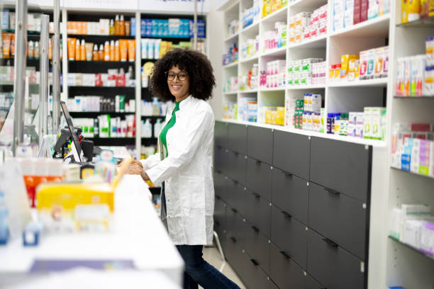 istock Happy African pharmacist standing in her workplace, surrounded by medicine 2179926774