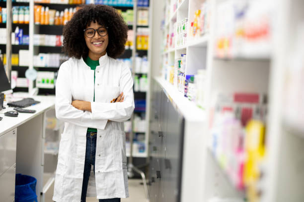 istock Female pharmacist, looking pleased while standing in her organized workspace 2179926785