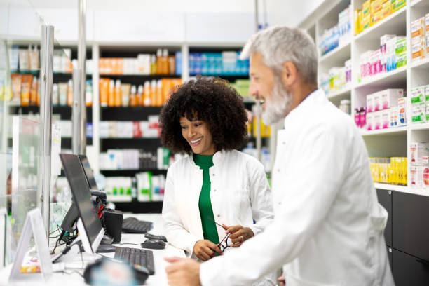 istock Young African pharmacist learning business from her experienced colleague 2179926808