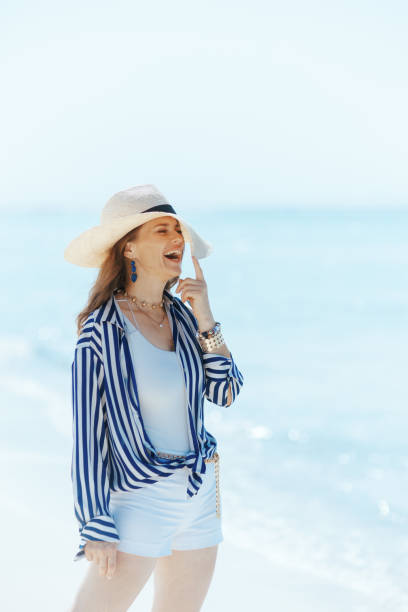 istock happy modern female on ocean coast with straw hat 2179927490