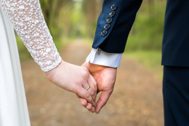 istock A pair of newlyweds holding hands. 2179927958