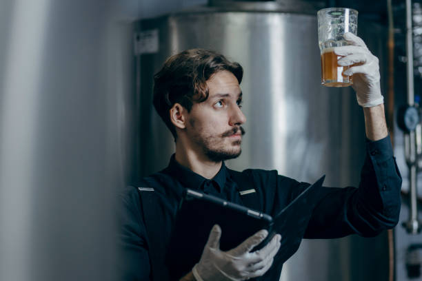 istock Young men inspecting quality of beer in brewery 2179930112