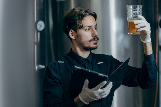 istock Young men inspecting quality of beer in brewery 2179930139