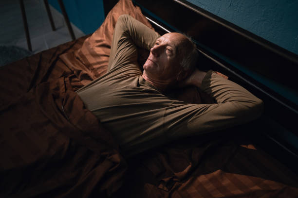 istock Sleepless elderly man lying in bed suffers from insomnia at night, depressed old male looking upset have health troubles concept thinking in bedroom 2179931149