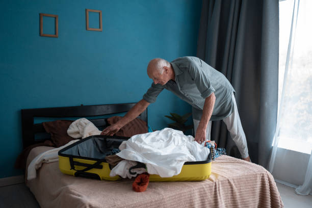 istock Senior man packing suitcase for his next trip. 2179931380
