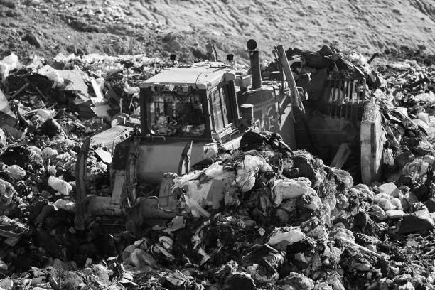 Overflowing domestic garbage at landfill background. Stock photo.