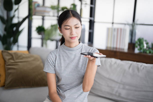 istock Asian woman using voice assistant on smartphone at home conversation with online assistantÂ Voice chat bot conversational AI Modern Technologies. 2179937588