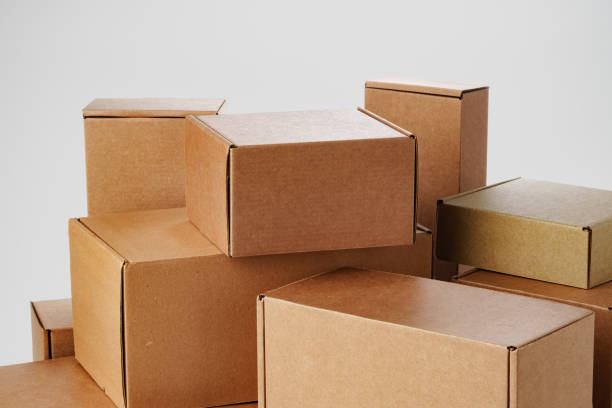 istock Stacked brown cardboard boxes in various sizes arranged on a white background 2179937975