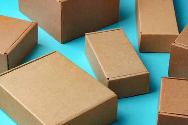 istock A collection of cardboard boxes arranged on a bright blue surface 2179938148