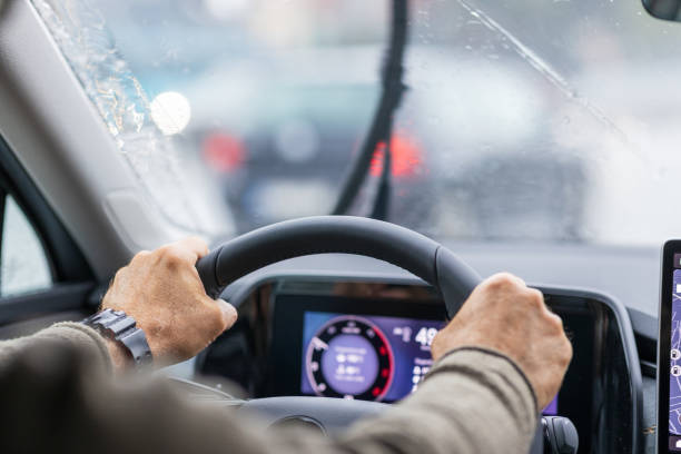 Rainy day traffic, hands on wheel, limited visibility