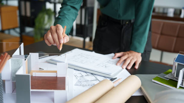istock Architecture Man drawing on architectural Creative project business architecture building constructionÂ Industrial engineering Achievement Planning Design on eco blueprint 2179938897