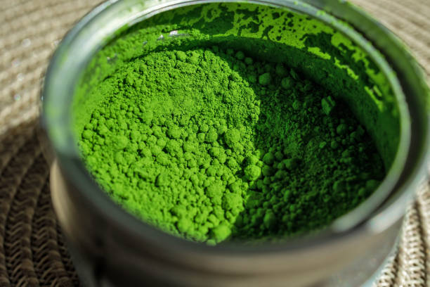 istock Vibrant green matcha tea powder in an open container 2179940338